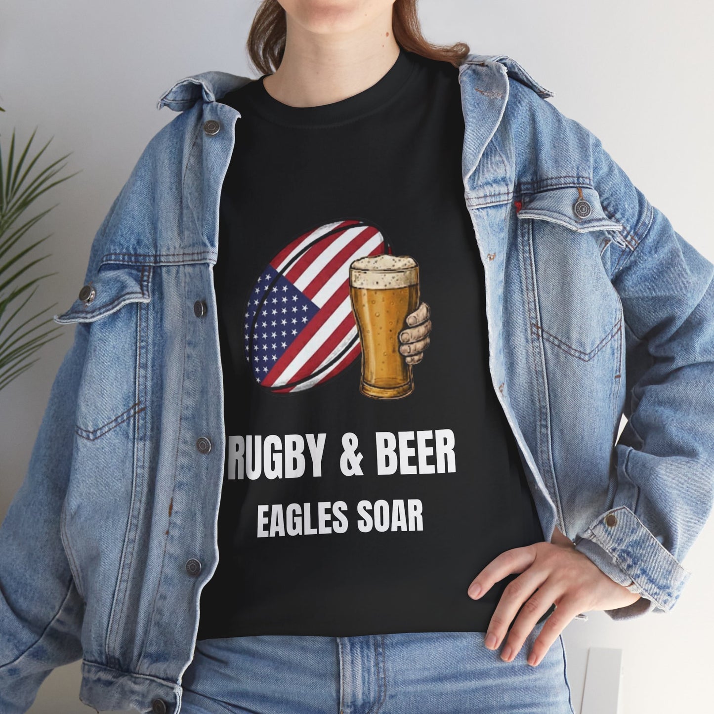 Lifestyle photo of a woman wearing Black Eagles Soar t-shirt with rugby and beer graphic and text on a white background