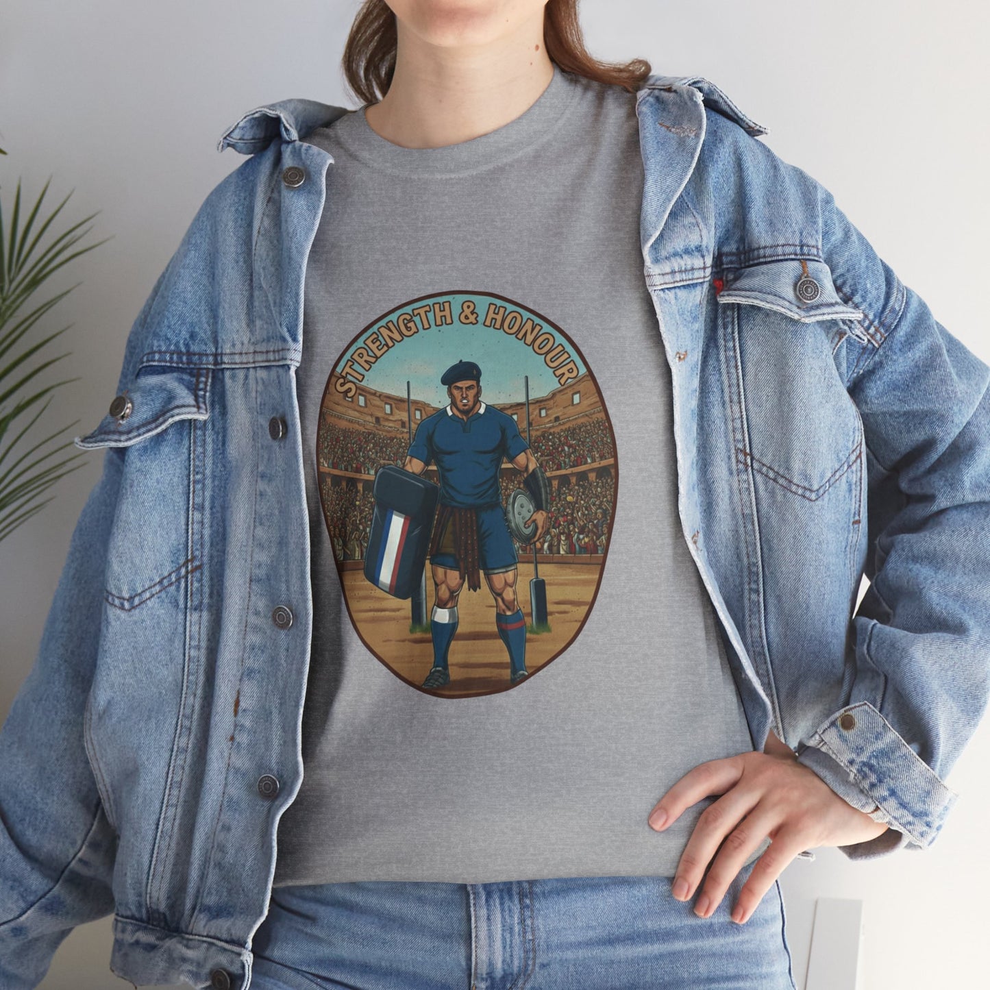 Lifestyle photo of a woman wearing a grey t-shirt with a graphic of a French rugby player and `Strength & Honour` text on a white background