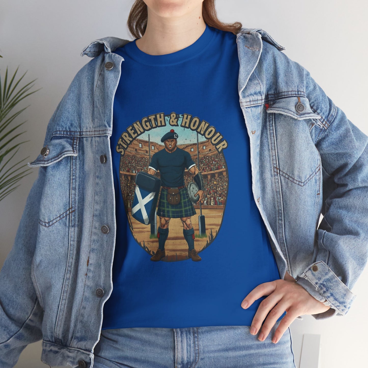 Lifestyle photo of a woman wearing a Blue t-shirt with a graphic of a Scottish rugby player wearing a kilt and `Strength & Honour` text on a white background