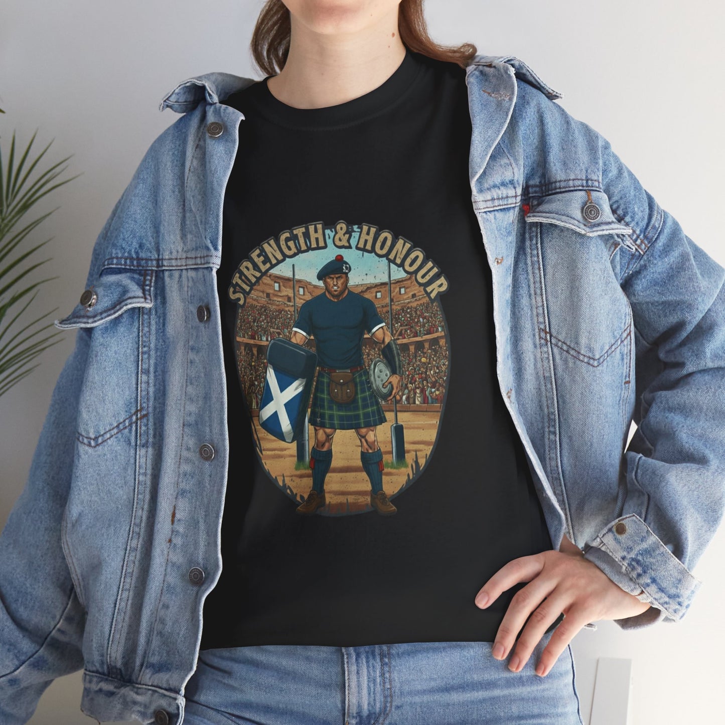 Lifestyle photo of a woman wearing a Black t-shirt with a graphic of a Scottish rugby player wearing a kilt and `Strength & Honour` text on a white background