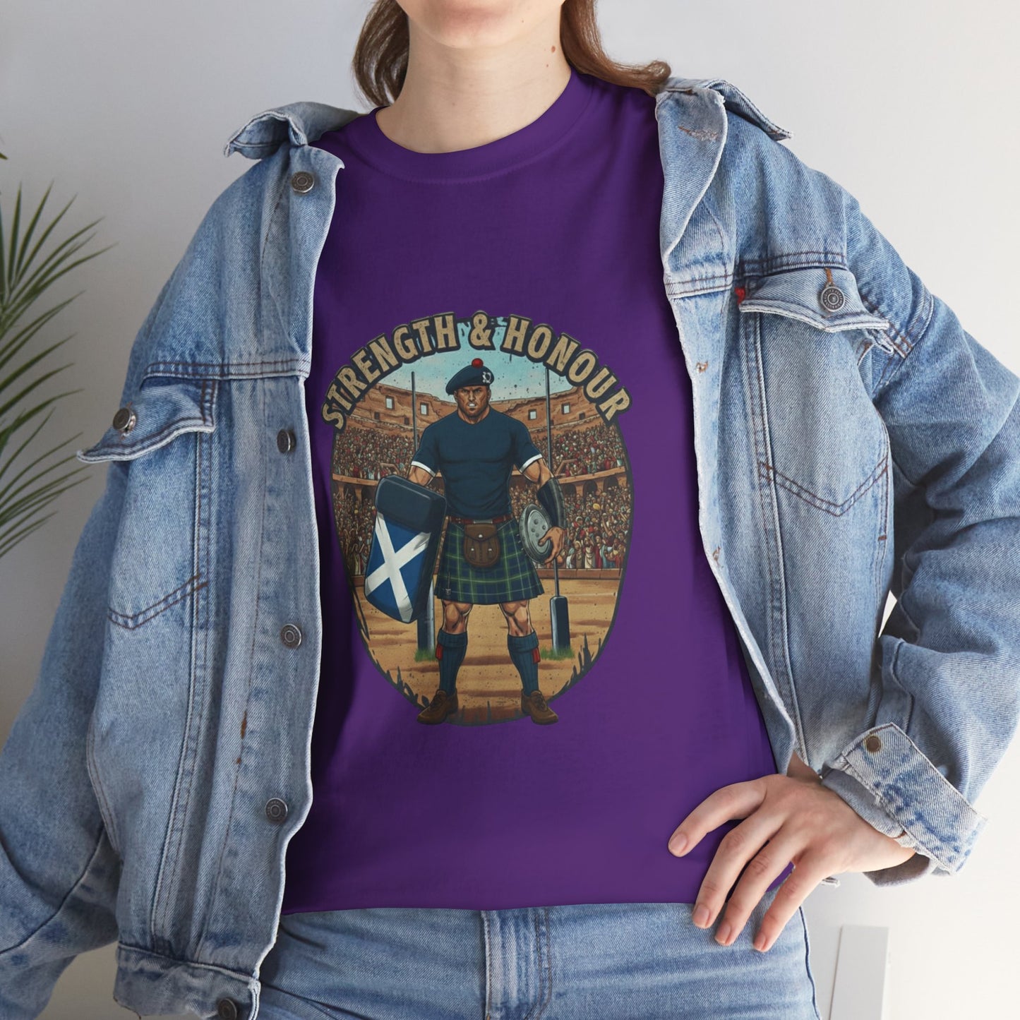 Lifestyle photo of a woman wearing a Purple t-shirt with a graphic of a Scottish rugby player wearing a kilt and `Strength & Honour` text on a white background