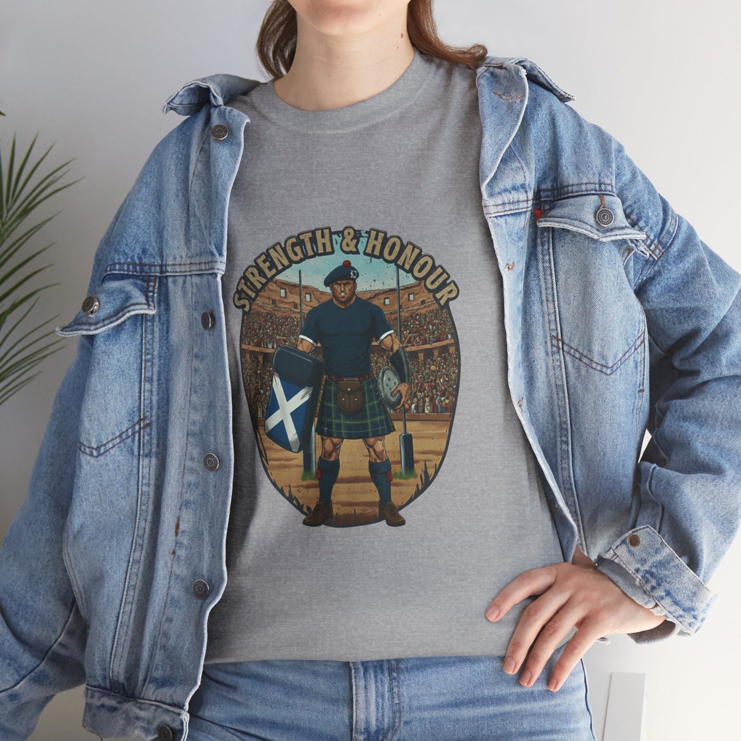 Lifestyle photo of a woman wearing a grey t-shirt with a graphic of a Scottish rugby player wearing a kilt and `Strength & Honour` text on a white background