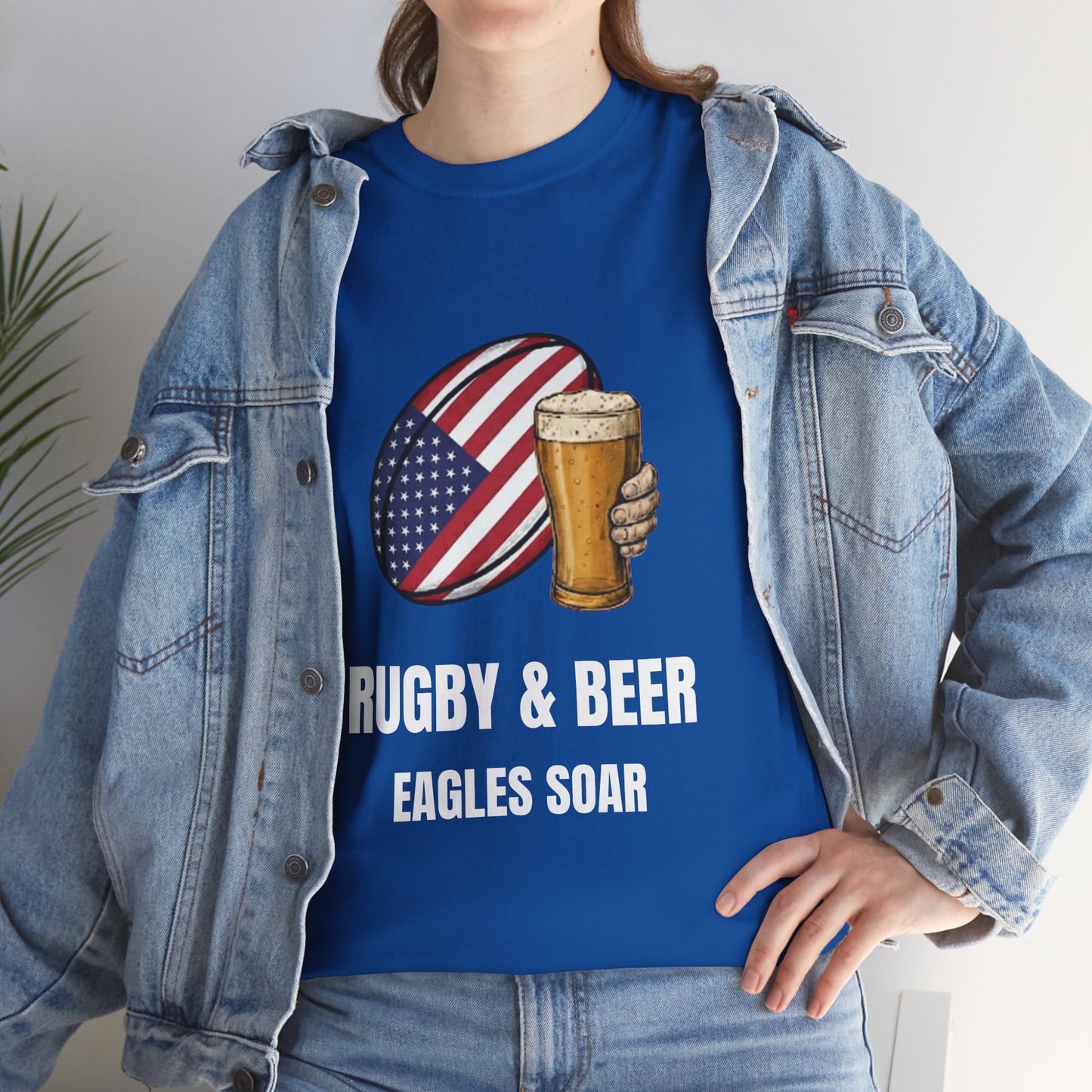 Lifestyle photo of a women wearing wearing Black Eagles Soar t-shirt with rugby and beer graphic and text on a white background