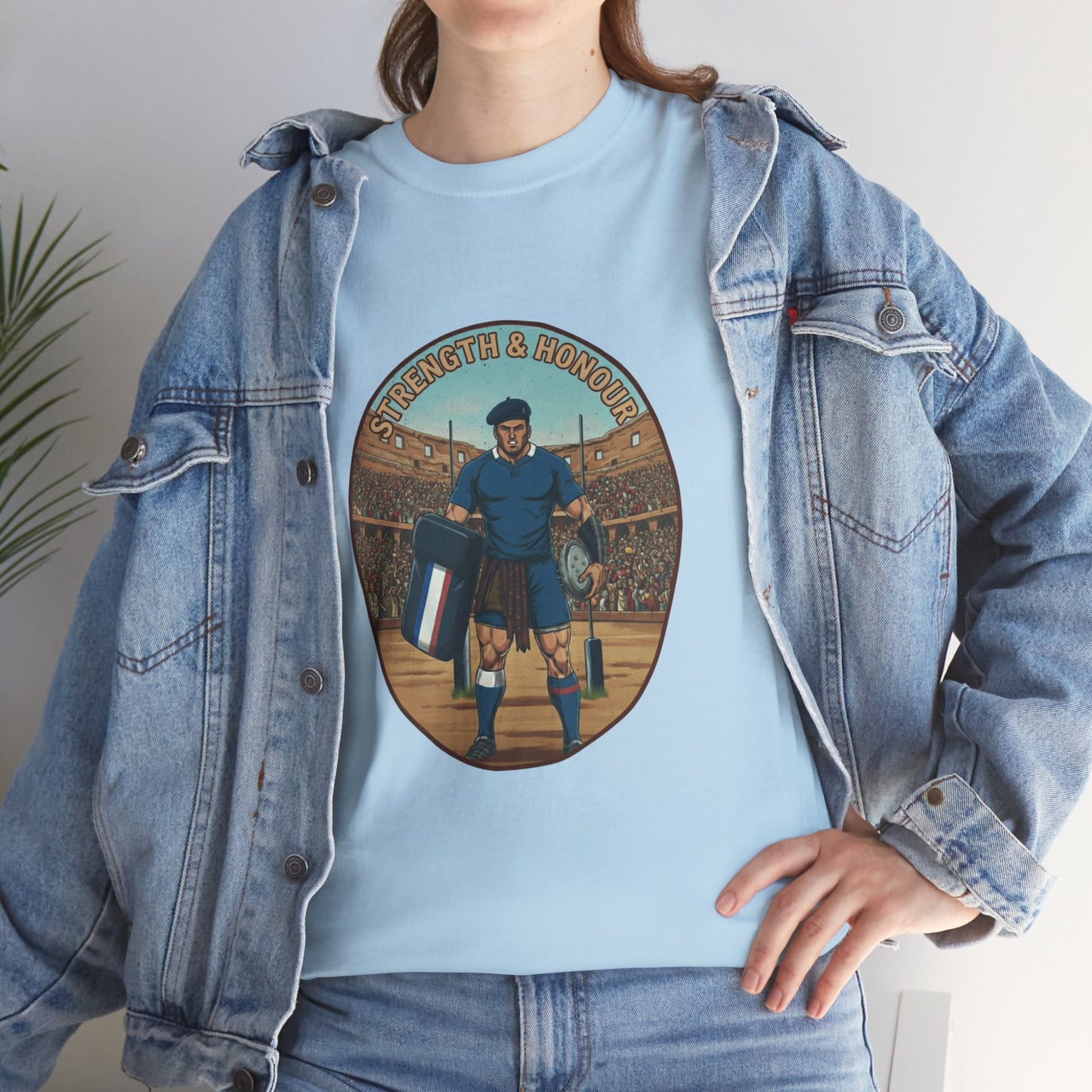 Lifestyle photo of a woman wearing a Light blue t-shirt with a graphic of a French rugby player and `Strength & Honour` text on a white background