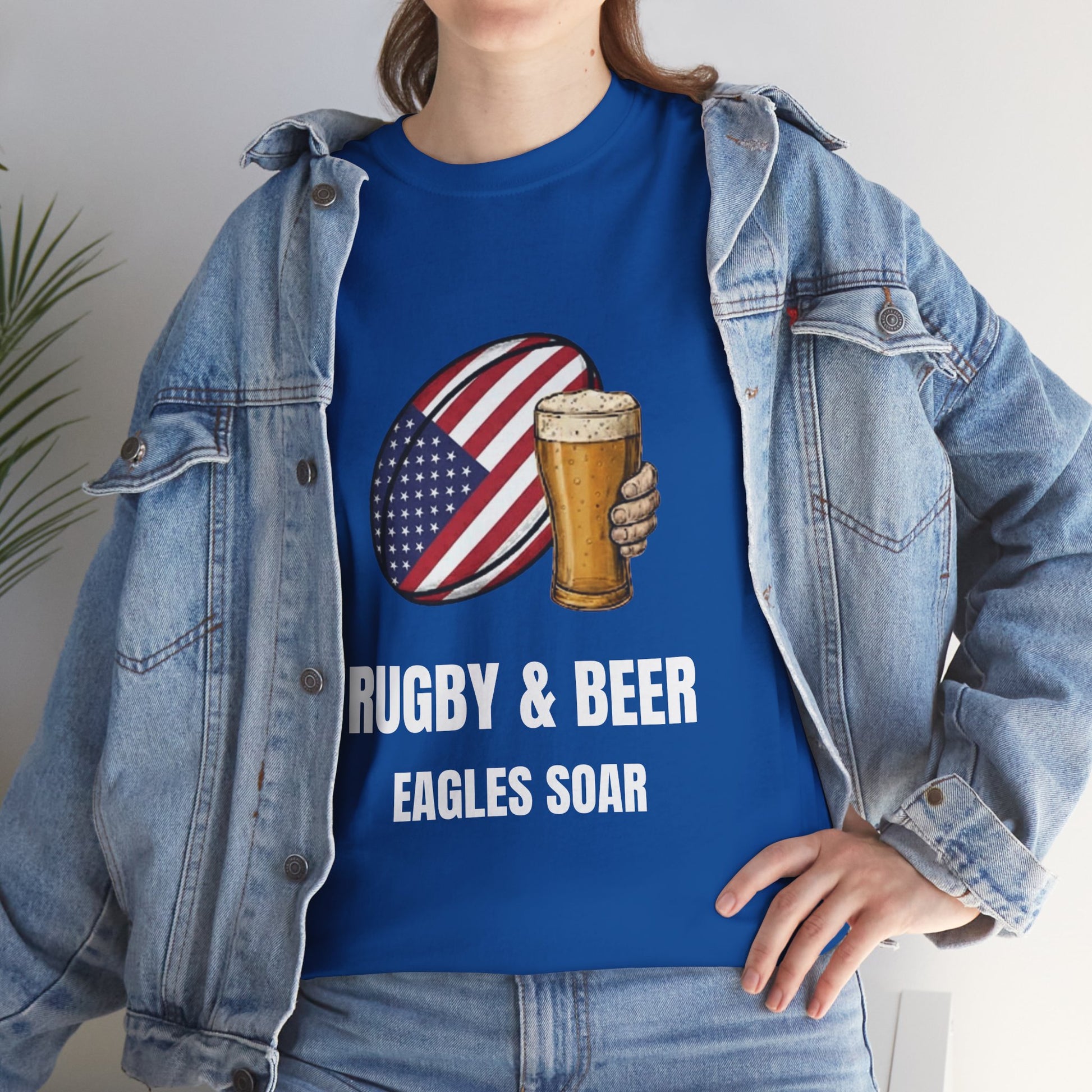 Lifestyle photo of a women wearing wearing Black Eagles Soar t-shirt with rugby and beer graphic and text on a white background